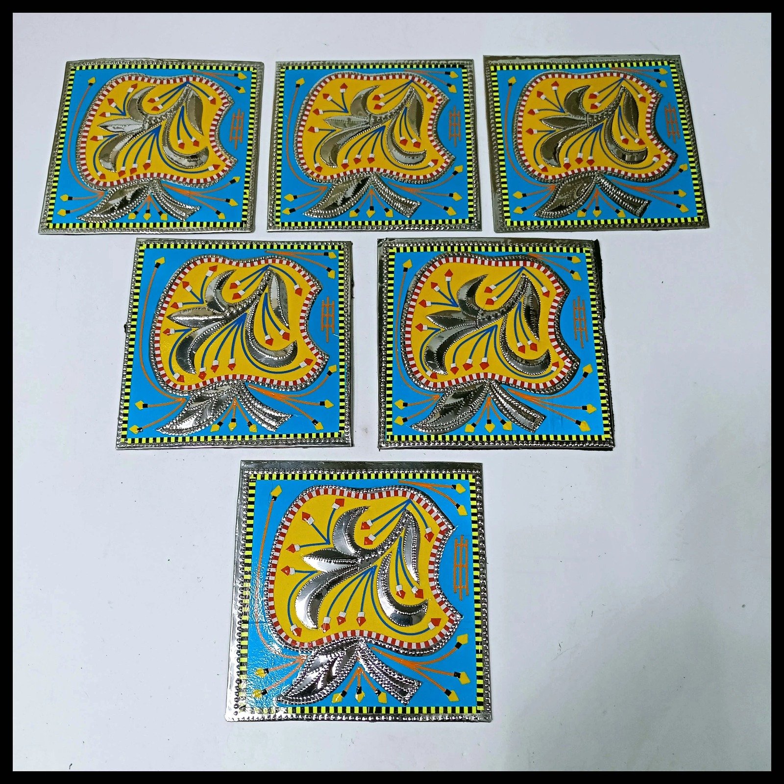 Set of six blue and yellow Chamakpatti coasters laid out
