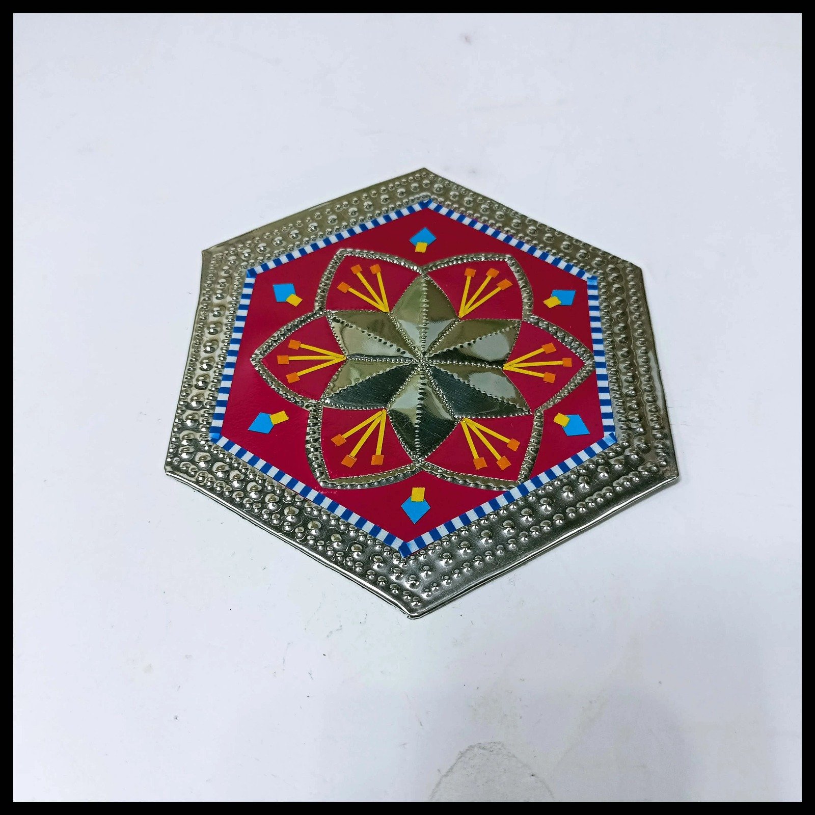 Top view of a single handcrafted Pakistani truck art coaster